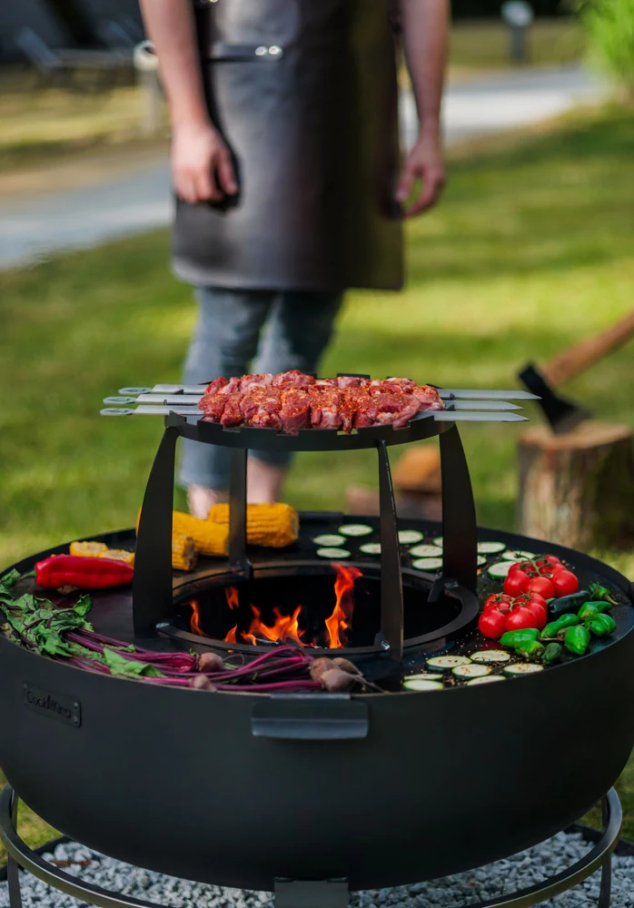 Kebabs and vegetables on a COOK KING fire bowl, seen from above